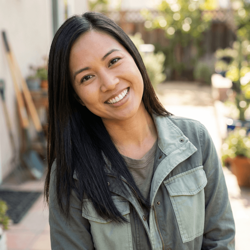 Professional female home organizer smiling in a bright organized closet